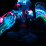 Metaverse. Woman in VR glasses playing AR augmented reality NFT game with neon blur lines