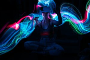 Metaverse. Woman in VR glasses playing AR augmented reality NFT game with neon blur lines