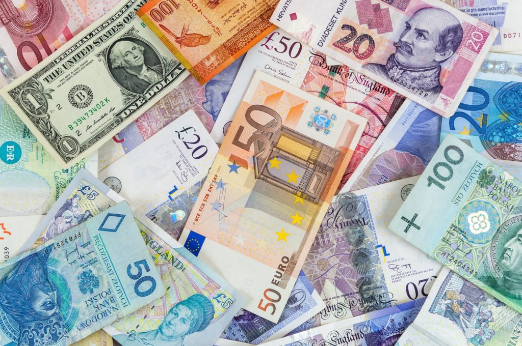 Different currencies banknotes background