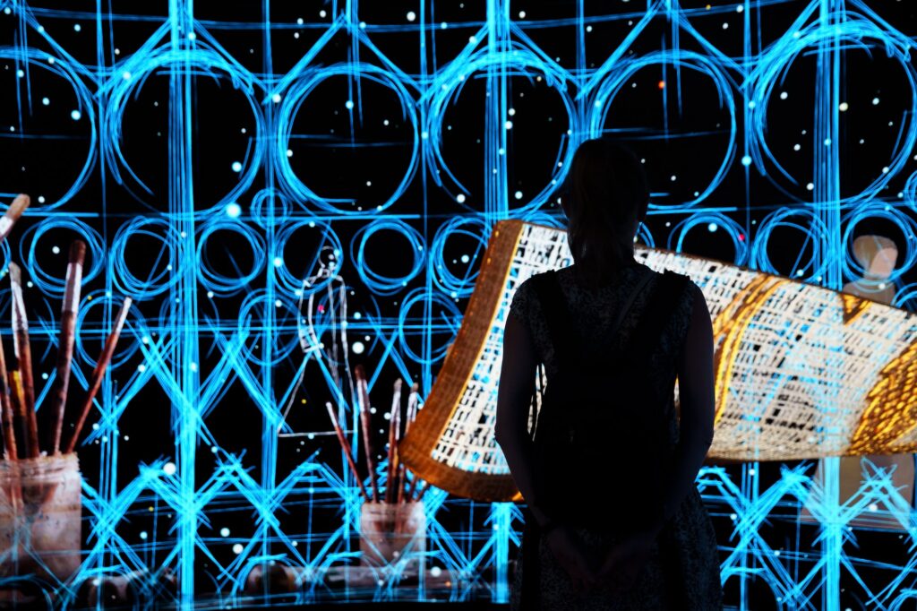 Woman silhouette in front of Digital art panel in one of the Expo in Dubai
